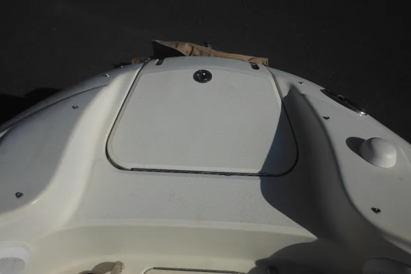 Slide: The Image of 2005 Sea Ray 220 Sundeck boat deck, featuring a closed hatch and sleek design. - 35