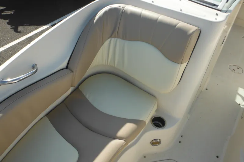 Slide: The Image of 2005 Sea Ray 220 Sundeck interior seating with beige and white upholstery. - 38