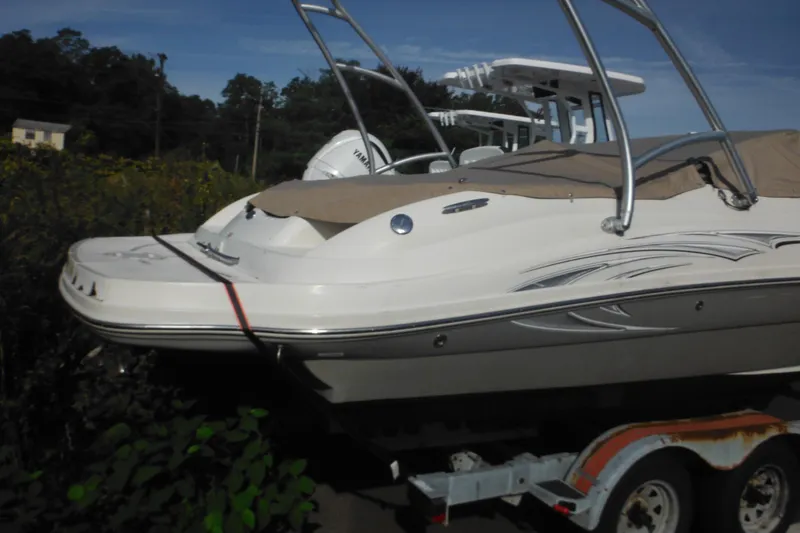 Slide: The Image of 2005 Sea Ray 220 Sundeck boat on trailer, covered and parked outdoors. - 4