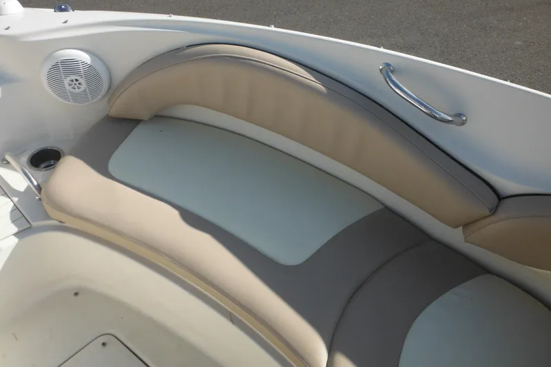 Slide: The Image of 2005 Sea Ray 220 Sundeck interior seating with speaker and cup holder. - 40
