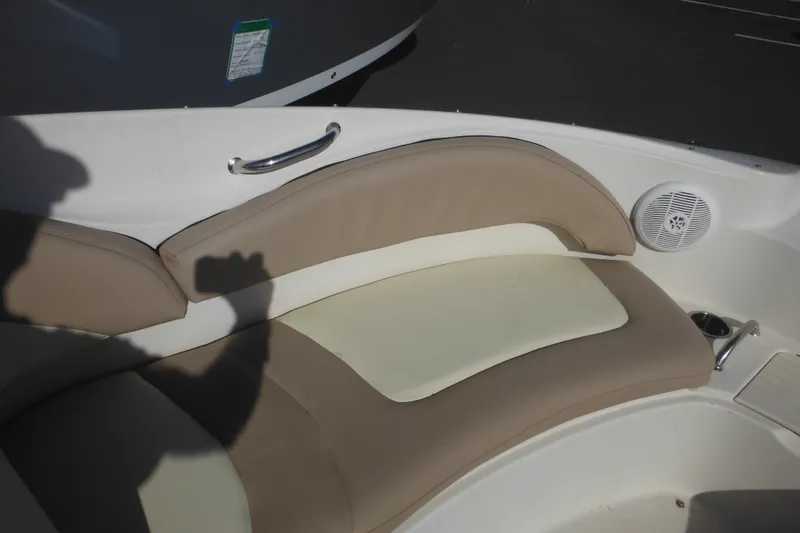Slide: The Image of 2005 Sea Ray 220 Sundeck interior with beige seating and speaker. - 41