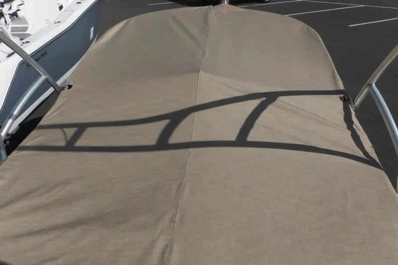 Slide: The Image of 2005 Sea Ray 220 Sundeck with protective cover in a parking lot. - 49