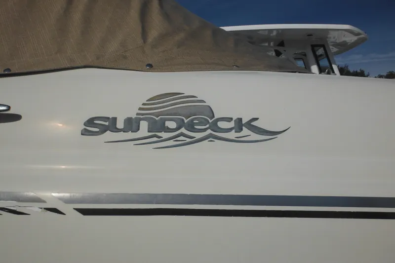 Slide: The Image of 2005 Sea Ray 220 Sundeck boat logo on white hull with cover. - 5