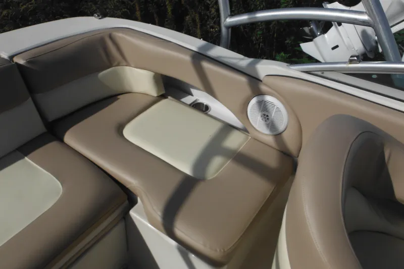 Slide: The Image of 2005 Sea Ray 220 Sundeck interior with beige seating and speaker. - 8