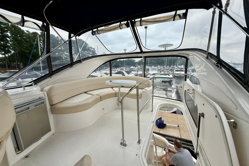 Slide: The Image of 2011 Meridian 341 Sedan interior with seating, table, and marina view. - 10