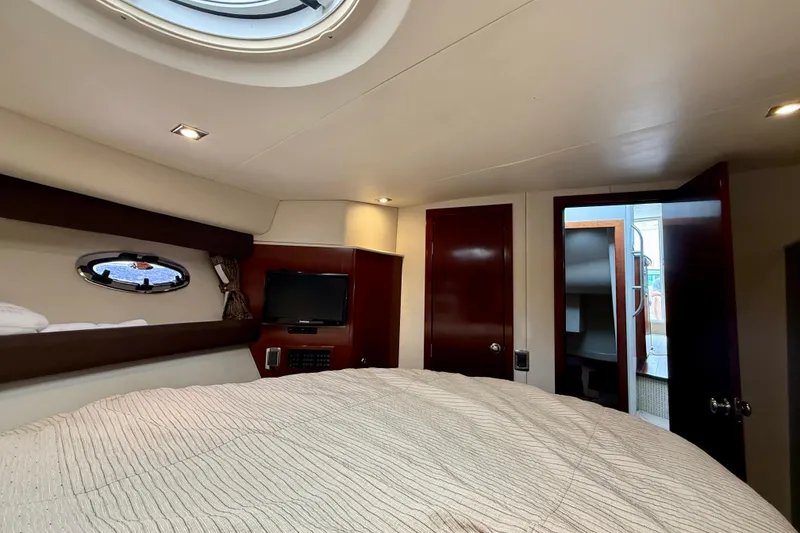 Slide: The Image of Luxurious interior of 2011 Meridian 341 Sedan yacht with cozy bed and porthole view. - 16