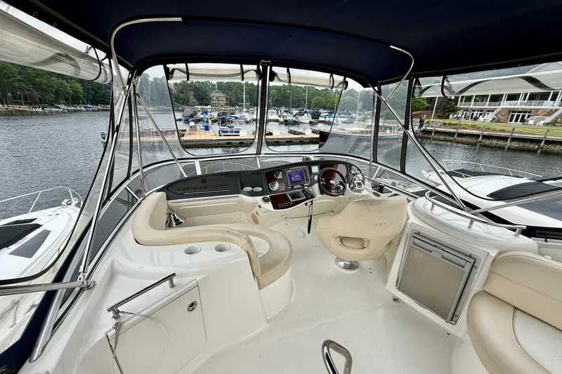 Slide: The Image of 2011 Meridian 341 Sedan yacht interior with helm, seating, and marina view. - 30