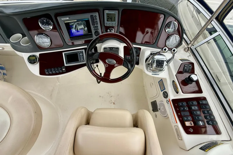 Slide: The Image of 2011 Meridian 341 Sedan helm with steering wheel, navigation controls, and dashboard instruments. - 31