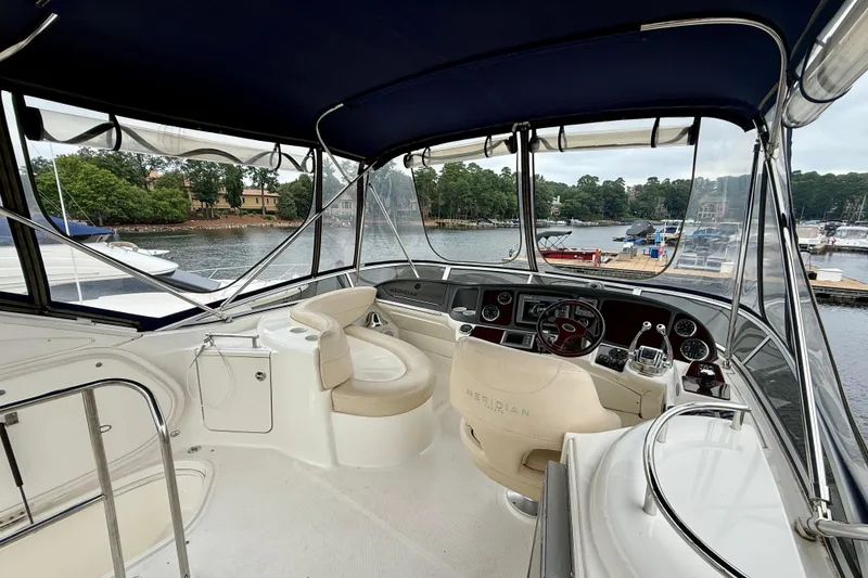 Slide: The Image of 2011 Meridian 341 Sedan yacht interior with helm, docked at scenic marina. - 32