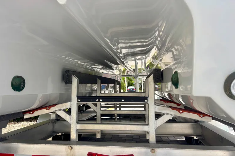 Slide: The Image of Underneath view of a 2024 World Cat 325 CC boat on a trailer. - 15
