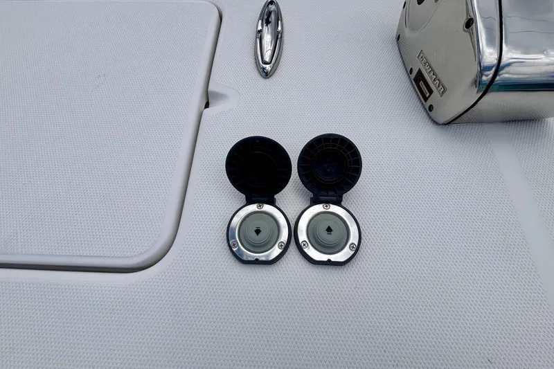 Slide: The Image of 2024 World Cat 325 CC boat deck with open fuel caps and stainless steel fittings. - 20