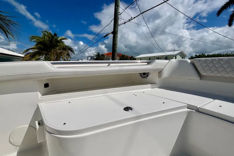 Slide: The Image of 2024 World Cat 325 CC boat interior with seating, under a clear blue sky. - 28