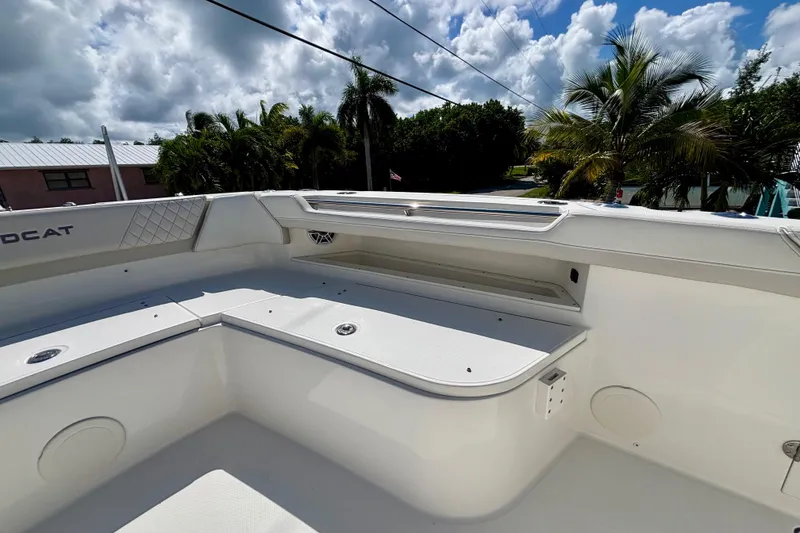 Slide: The Image of 2024 World Cat 325 CC boat interior with seating, under a partly cloudy sky. - 29