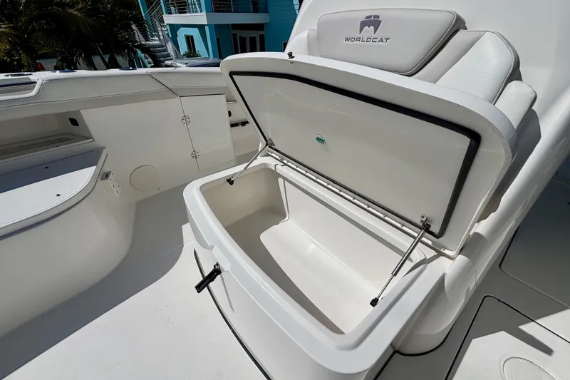 Slide: The Image of 2024 World Cat 325 CC boat with open storage compartment, showcasing sleek interior design. - 31