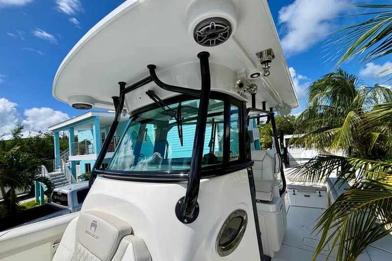 Slide: The Image of 2024 World Cat 325 CC boat with sleek design, palm trees, and blue sky background. - 34