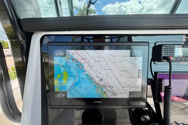 Slide: The Image of 2024 World Cat 325 CC boat dashboard with Garmin navigation display. - 37