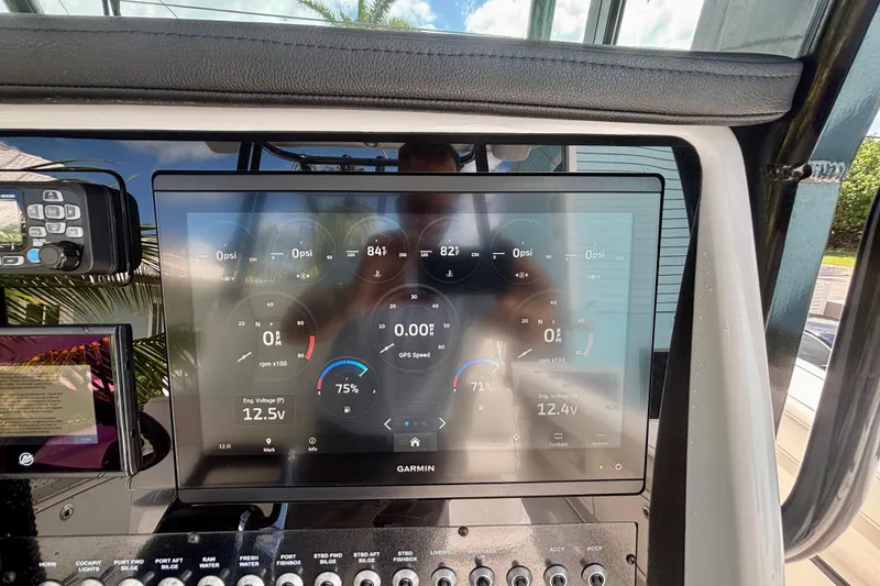 Slide: The Image of Dashboard of a 2024 World Cat 325 CC boat with Garmin display and controls. - 38