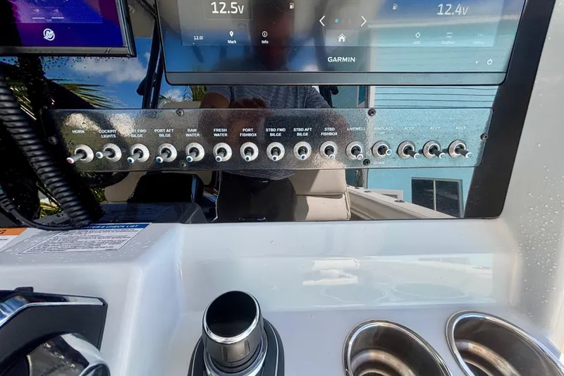 Slide: The Image of Control panel of 2024 World Cat 325 CC boat with switches and Garmin display. - 40