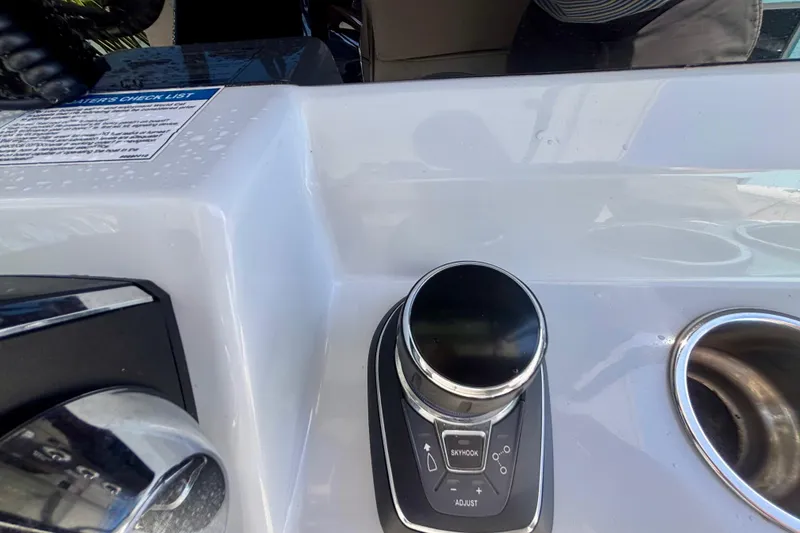 Slide: The Image of Control panel of 2024 World Cat 325 CC boat with joystick and cup holder. - 42