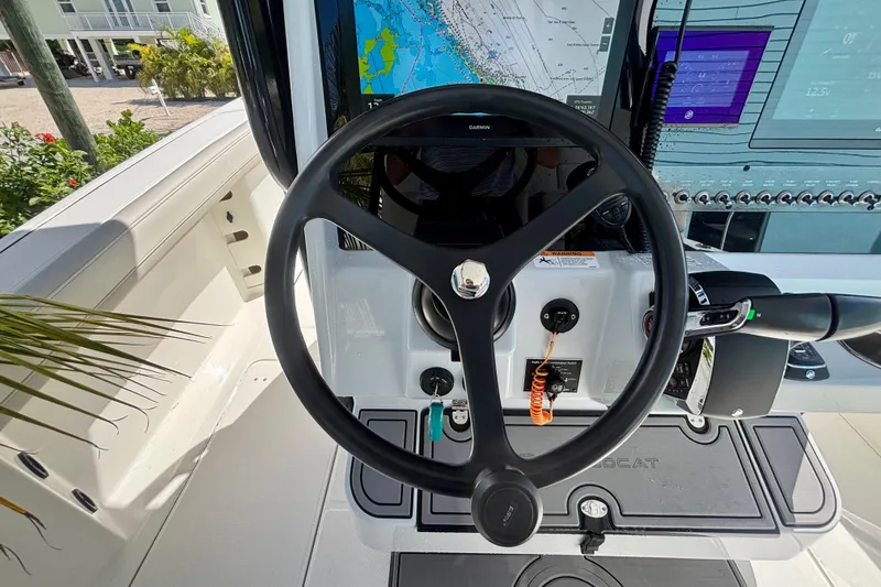 Slide: The Image of 2024 World Cat 325 CC helm with steering wheel and navigation display. - 43