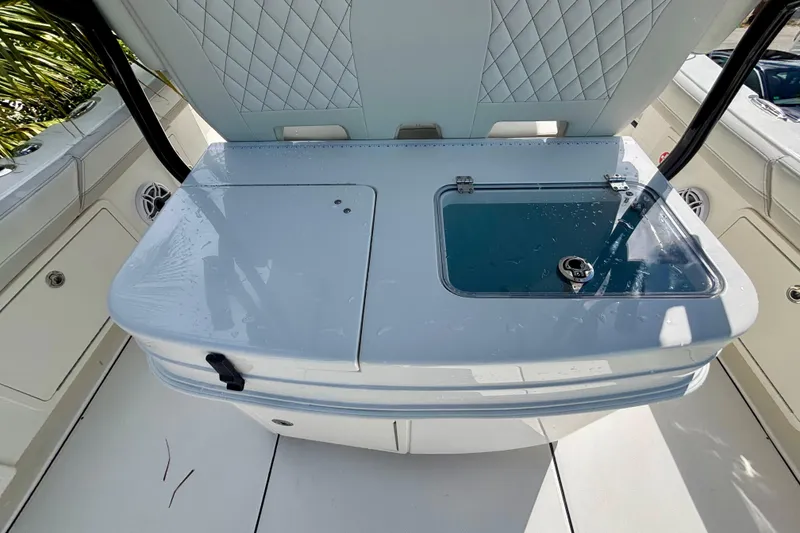 Slide: The Image of 2024 World Cat 325 CC boat interior with storage and seating area. - 52