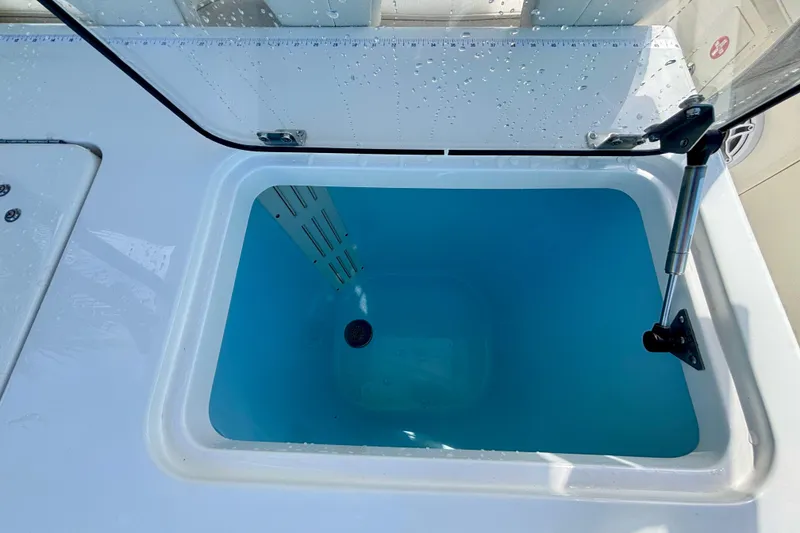 Slide: The Image of 2024 World Cat 325 CC livewell with open lid, showcasing interior design. - 54