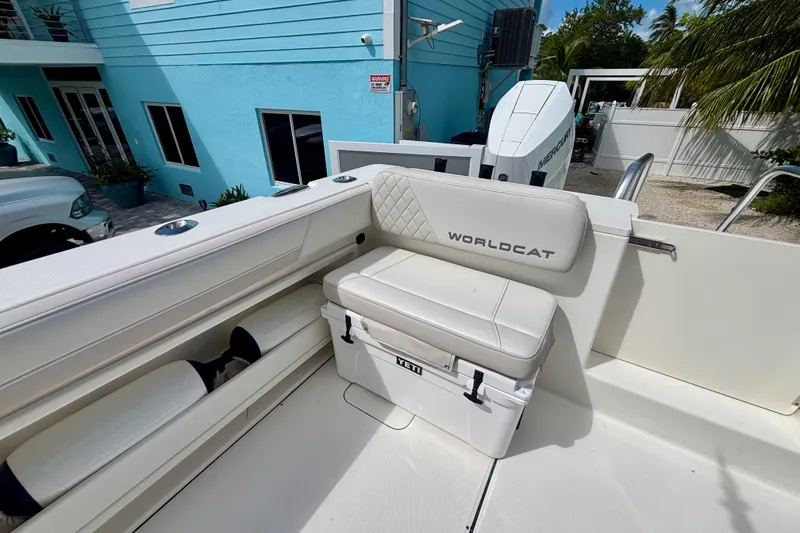 Slide: The Image of 2024 World Cat 325 CC boat interior with cushioned seating and storage. - 56