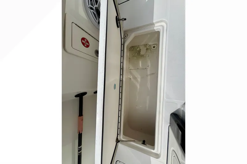 Slide: The Image of Open storage compartment on 2024 World Cat 325 CC boat, featuring a clean interior. - 59