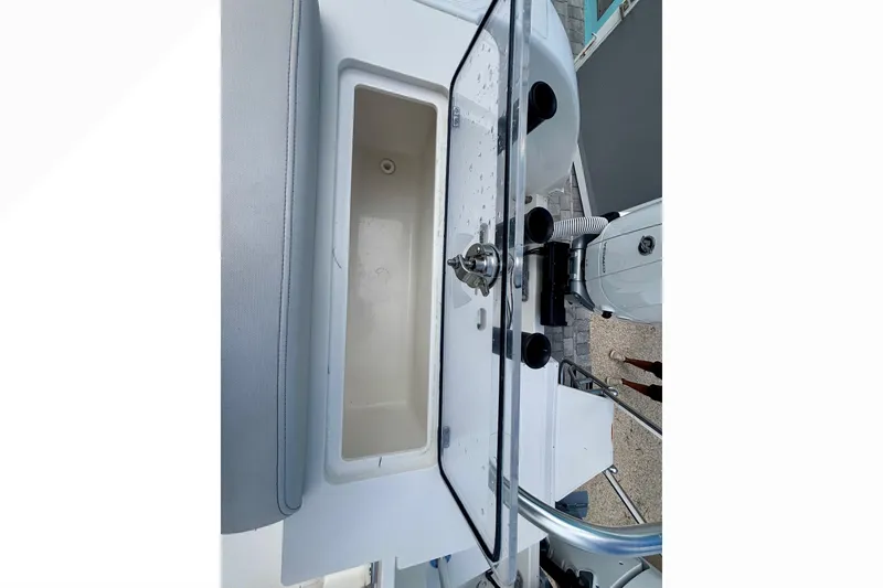 Slide: The Image of 2024 World Cat 325 CC boat interior with storage compartment and equipment. - 60