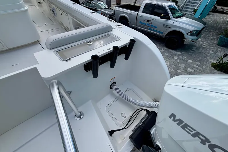 Slide: The Image of 2024 World Cat 325 CC boat deck with rod holders and Mercury engine. - 63