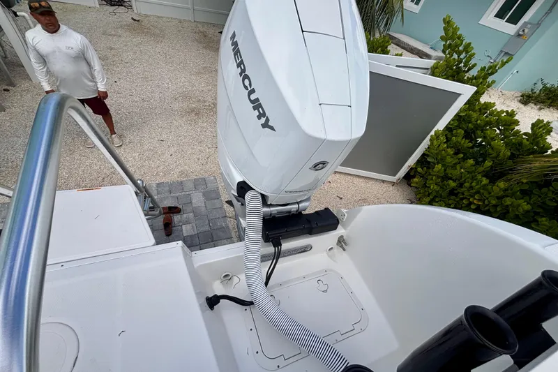 Slide: The Image of 2024 World Cat 325 CC boat with Mercury engine, outdoor setting. - 65