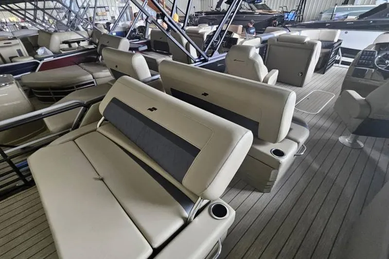Slide: The Image of 2026 Starcraft CX 23 DL boat interior with beige seating and cup holders. - 7