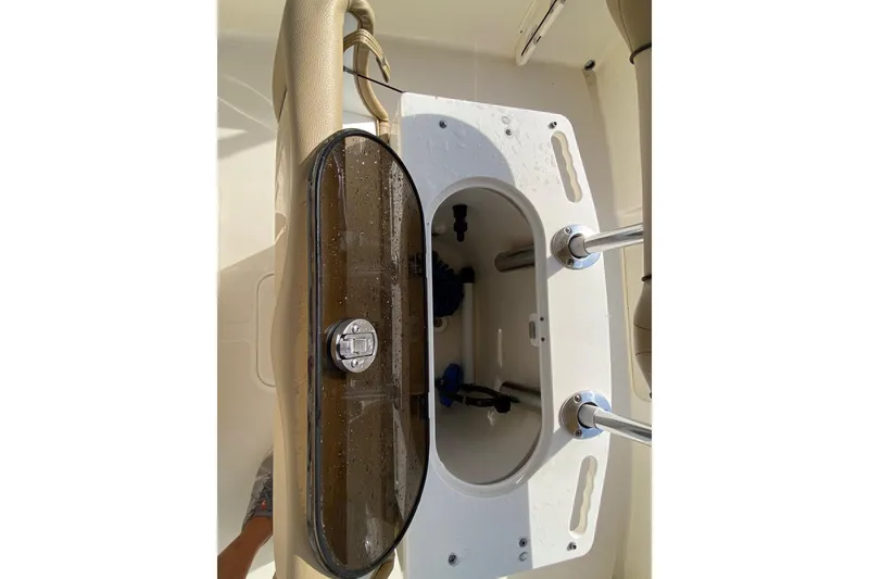 Slide: The Image of 2018 Scout 195 Sportfish boat interior with beige seating and 115 horsepower engine. - 11