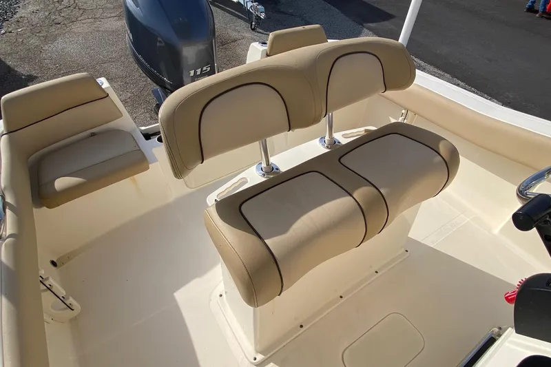 Slide: The Image of 2018 Scout 195 Sportfish boat interior with Yamaha 115 engine, featuring beige seating. - 15