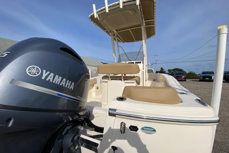 Slide: The Image of 2018 Scout 195 Sportfish boat with Yamaha outboard motor, parked outdoors. - 4