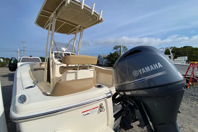 Slide: The Image of 2018 Scout 195 Sportfish boat with Yamaha outboard motor, parked outdoors. - 5