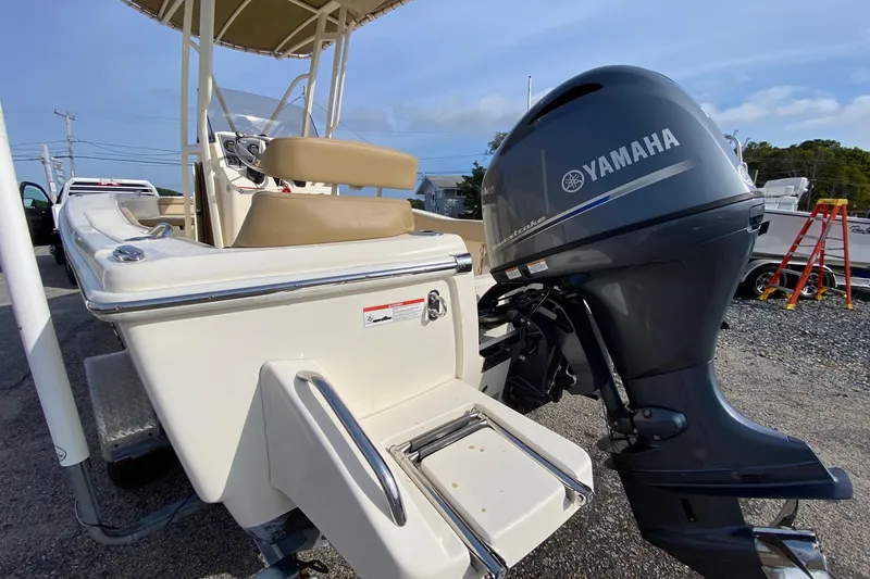 Slide: The Image of 2018 Scout 195 Sportfish boat interior with beige seating and speakers. - 6