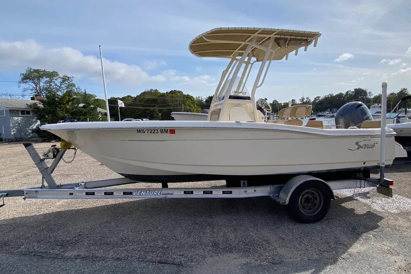 Slide: The Image of 2018 Scout 195 Sportfish boat interior with portable toilet and wiring. - 7