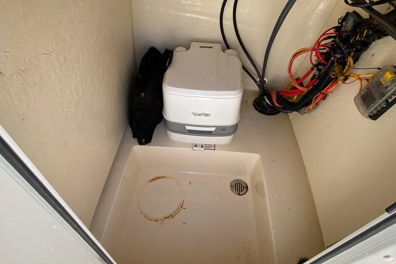 Slide: The Image of 2018 Scout 195 Sportfish boat interior with storage compartment and rod holders. - 9