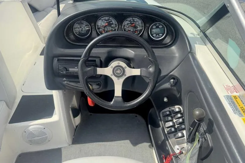 Slide: The Image of 2004 Centurion ELITE V boat dashboard with steering wheel and control panel. - 13