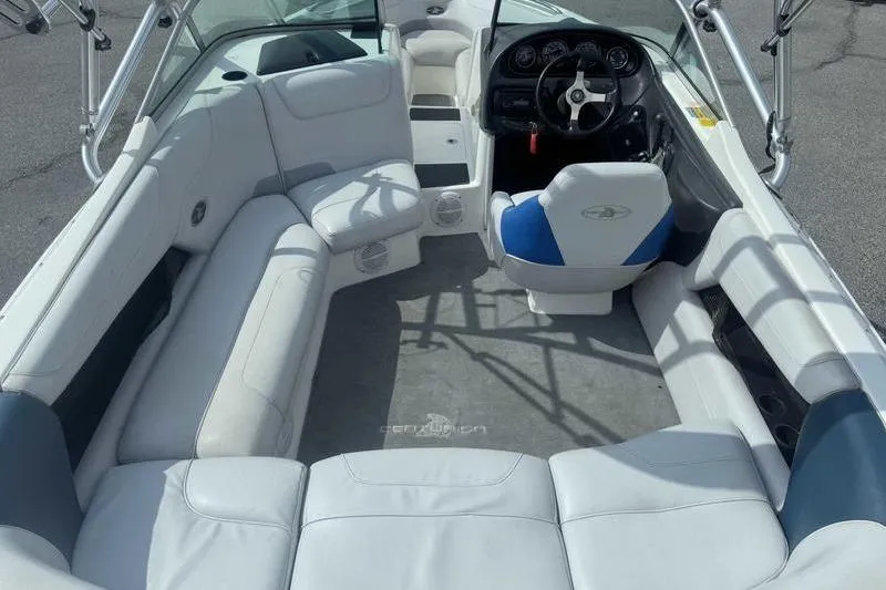 Slide: The Image of 2004 Centurion ELITE V boat interior with white seating and steering wheel. - 14