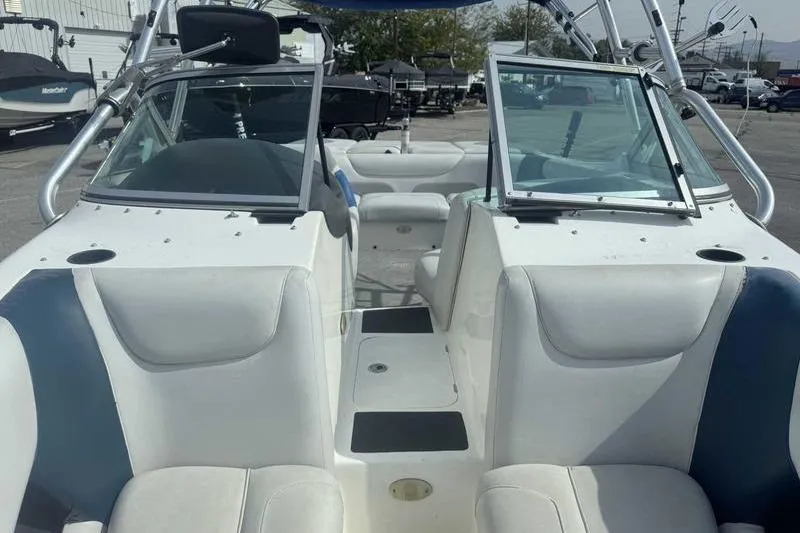 Slide: The Image of 2004 Centurion ELITE V boat interior with white seating and open windshield. - 6