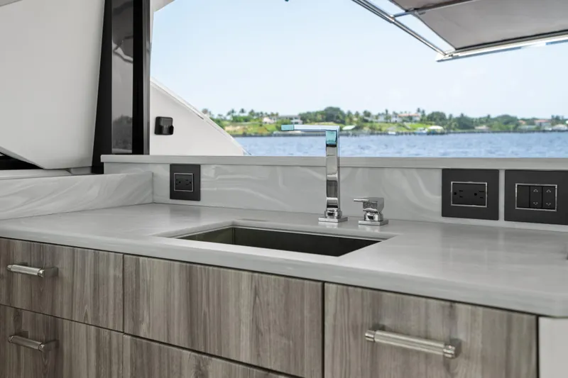 Slide: The Image of 2024 Formula 500 Super Sport Crossover boat interior with luxurious seating and table on water. - 18