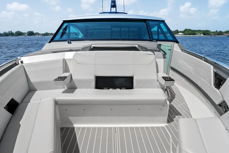 Slide: The Image of Luxurious 2024 Formula 500 Super Sport Crossover yacht deck with seating, overlooking serene waters. - 47