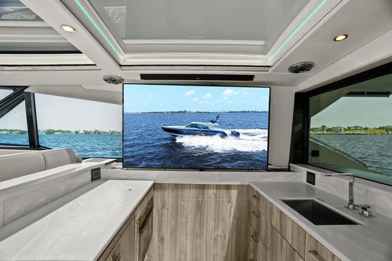 Slide: The Image of 2024 Formula 500 Super Sport Crossover yacht interior with modern kitchen and panoramic windows. - 73