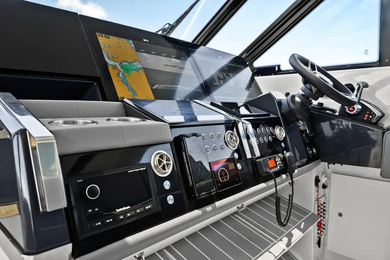 Slide: The Image of 2024 Formula 500 Super Sport Crossover helm with advanced navigation displays and controls. - 79