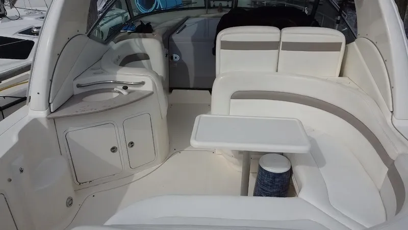 Slide: The Image of 2005 Sea Ray 320 Sundancer cockpit with seating and table. - 11