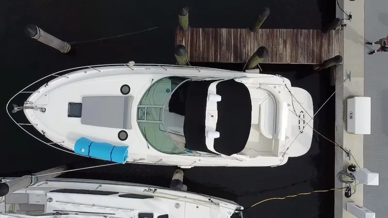 Slide: The Image of Top view of a 2005 Sea Ray 320 Sundancer docked at a marina. - 7