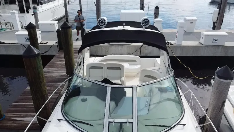 Slide: The Image of 2005 Sea Ray 320 Sundancer docked at a marina, front view. - 8