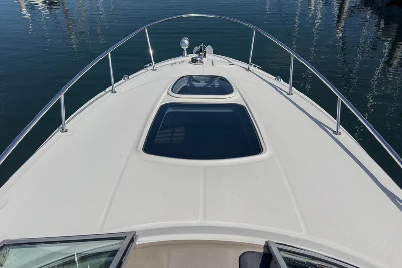 Slide: The Image of 2016 Sea Ray 280 Sundancer boat deck with sleek design and water reflection. - 10